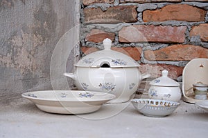 Home Collection of antique, vintage dishes, tableware, dinnerware, kitchen utensils with patina and craquelure.