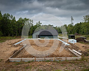 Home construction site with wood forms prepared for concrete cement