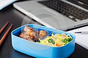 Home cook bento box during office lunch with computer laptop