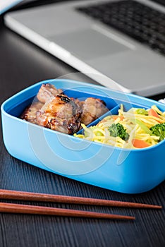 Home cook bento box during office lunch with computer laptop