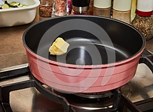 Home Cooking: Butter and Frying Pan on Stove for Delicious Meal Preparation