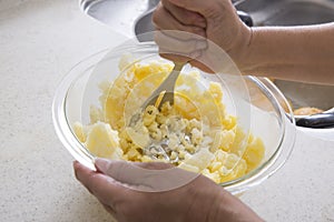 Home cooking scene, crushing potatoes