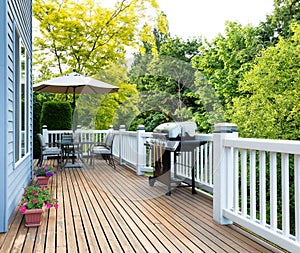 Home deck and patio with outdoor furniture and BBQ cooker with b