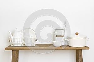 Home decor concept with kitchen utensils and dishware on table