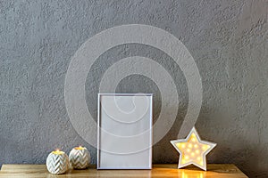 Home decor mockup, blank photo frame near gray painted concrete wall. Place for your text