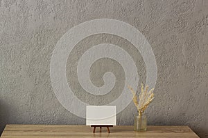 Home decor mockup, blank photo frame near gray painted concrete wall. Place for your text