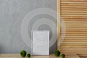 Home decor mockup, blank photo frame near gray painted concrete wall. Place for your text