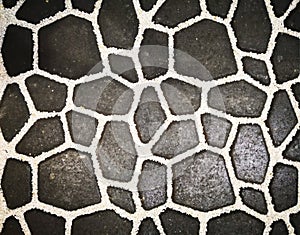 Home decoration concept and abstract background. Small black brick blocks are lined with small white stones decorated between ind