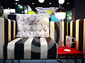 Home decoration concept. White cushion with black flowers patter