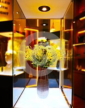 Home decoration concept. The yellow flower bouquet is in a brown