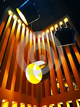 Home decoration concept. Yellow light bulb in the black lamp. It