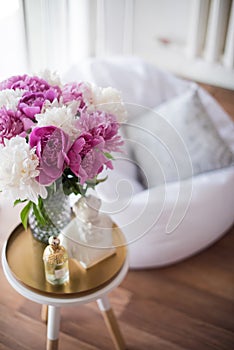 home decoration, fresh pink peonies on coffee table in white roo