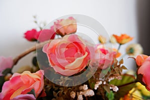 Close up of red roses fake flowers composition macro, flowers decoration ornamental background, made from fabric and plastic