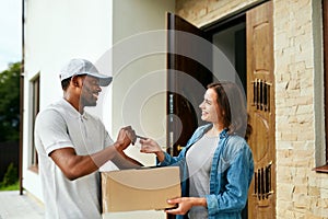 Home Delivery. Courier Delivering Package To Client