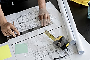 Home design architects are editing the drafts of the house plans.