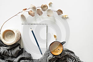 Home desk table with plaid, coffee cup on white background