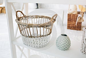 Home details decorations lying on the shelf. Wooden background. Loft style. Cosy rustic mood. Nuts in the jar. Straw basket