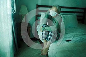 Home dramatic portrait of  attractive middle aged woman 50s with grey hair and protective mask during covid-19 virus lockdown