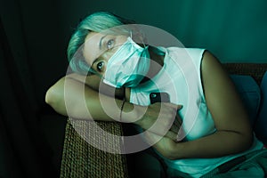 Home dramatic portrait of  attractive middle aged woman 50s with grey hair and protective mask during covid-19 virus lockdown