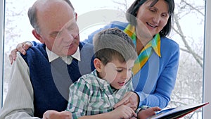 Home education, child with grandparents read book at leisure