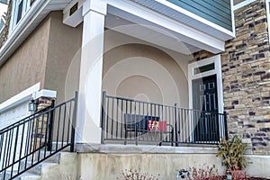 Home entrance with stairs and porch leading to front door with transom window