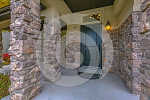 Home entrance with stone wall and porch in Utah