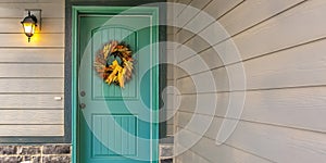 Home entrance with wreath on blue green front door