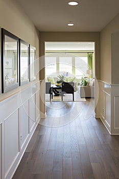 Home Entry Way with Wood Floors and Wainscoting