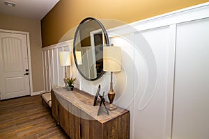 Home Entryway With Chest And Circular Mirror