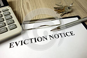 Home eviction notice legal document with pen calculator and keys