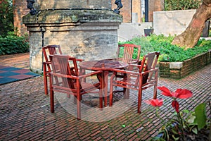 Home exterior patio with wooden decking and armchairs