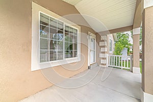 Home exterior with view of the large window and front door at the porch