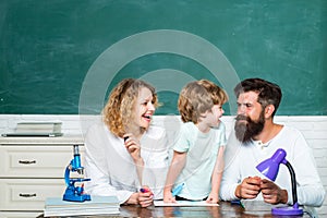 Home Family math schooling - Parents teaching kids private lessons in math. Happy young couple who are standing with