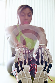 Home Fitness Black Woman Doing Legs Stretching On Pad