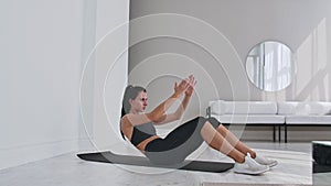 Home fitness concept. Woman doing abs crunches on floor at home, copy space.