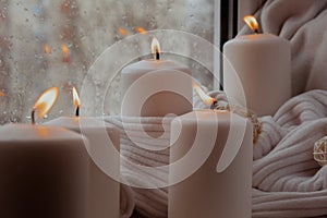 Home fragnance concept autumn holidays at cozy home on the windowsill Hygge aesthetic atmosphere on knitted white