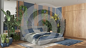 Home garden, minimal bedroom in blue and wooden tones. Velvet double bed, parquet floor and many houseplants. Urban jungle