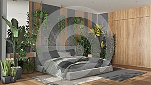 Home garden, minimal bedroom in gray and wooden tones. Velvet double bed, parquet floor and many houseplants. Urban jungle