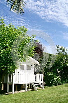 Home garden with a white hut