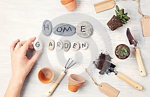 Home gardening concept. Flat lay with the text my garden on stones and gardening tools. Top view minimal