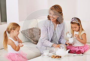 Home, granny and grandkids with tea party, sisters and bonding together in lounge. Apartment, grandmother or old woman