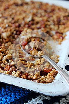 Home granola on a white baking sheet. Rustic style, selective focus.