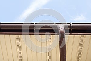 Home Guttering, Gutters, Plastic Guttering System, Guttering & Drainage Pipe Exterior against blue sky.