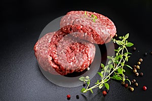 Home HandMade Raw Minced Beef steak burgers on black board