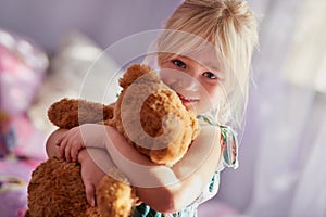 Home, happy and girl hug with teddy, comfort with animal toys for childhood development for cuddle portrait. Support