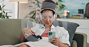 Home, headphones and woman with a smartphone, pet and streaming music in a lounge. Person, apartment and girl with sound