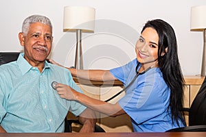 Home Health Care Nurse Assisting Elderly Patient