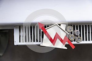 Home heating bills increase. Red up arrow with a house on a heating radiator