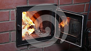 Home heating with wood using stone wood-burning stove during heating season.