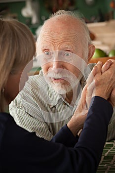 at home holding hands focusing on man